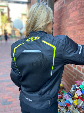 woman facing away showing the back of the gryphon motorcycle jacket