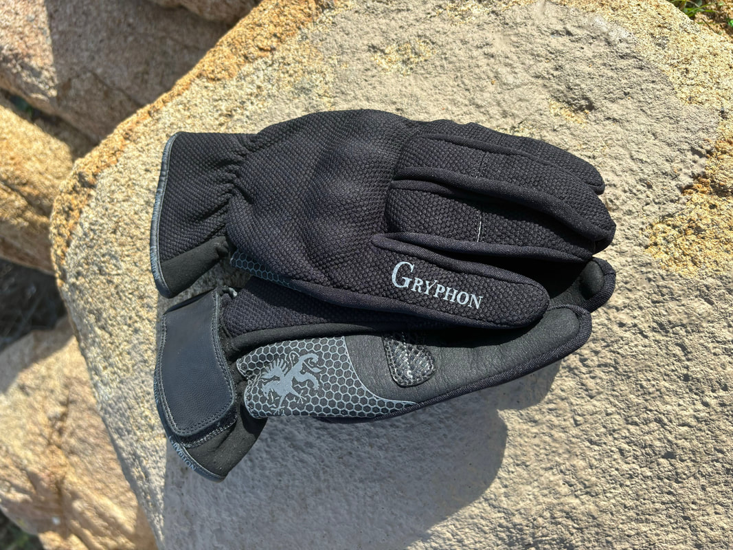 gryphon motorcycle gloves laying on a rock in the sun